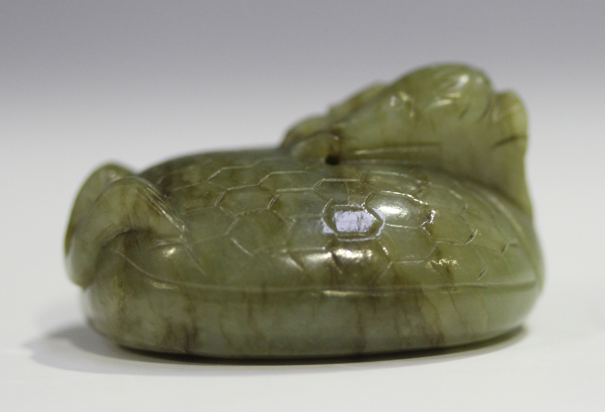 A Chinese carved celadon jade dragon pendant, 20th century, of oval shape, the stone with brown line - Image 9 of 10