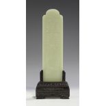 A Chinese pale celadon jade plaque, probably 20th century, of arched rectangular form, one side