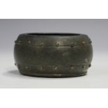 A Chinese brown patinated bronze water coupe, Qing dynasty, modelled in the form of a drum with stud
