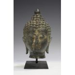 A South-east Asian bronze Buddha head, probably 18th/19th century, cast with eyes closed and