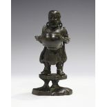 A Chinese brown patinated bronze figure, Qing dynasty, the bearded gentleman modelled holding a