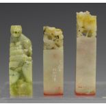 Three Chinese soapstone seals, 20th century, each with carved surmount, comprising dragon, phoenix