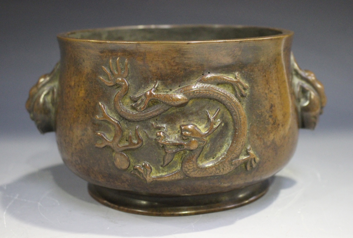 A Chinese brown patinated bronze bombé censer, the body cast in relief with opposing dragons,