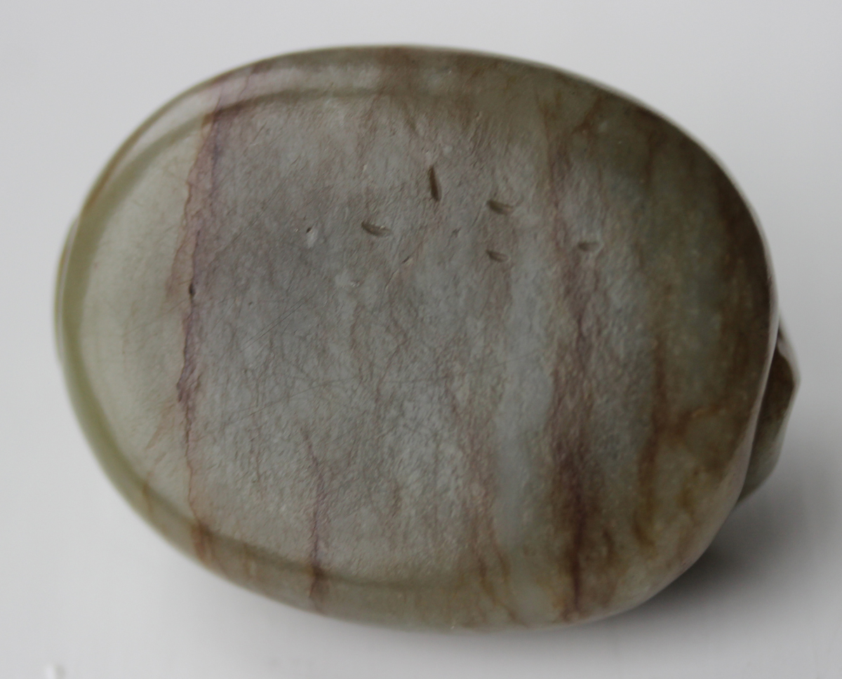 A Chinese carved celadon jade dragon pendant, 20th century, of oval shape, the stone with brown line - Image 4 of 10