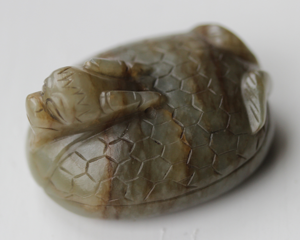 A Chinese carved celadon jade dragon pendant, 20th century, of oval shape, the stone with brown line - Image 5 of 10