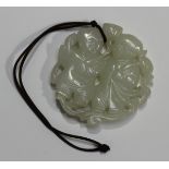 A Chinese white jade circular pendant, probably 20th century, carved and pierced with two boys,