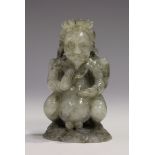 A Chinese carved jade figure of a deity, modelled seated wearing a crown above wings, the stone of