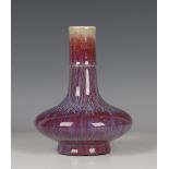 A Chinese flambé glazed porcelain vase, 20th century, the compressed bulbous body beneath an