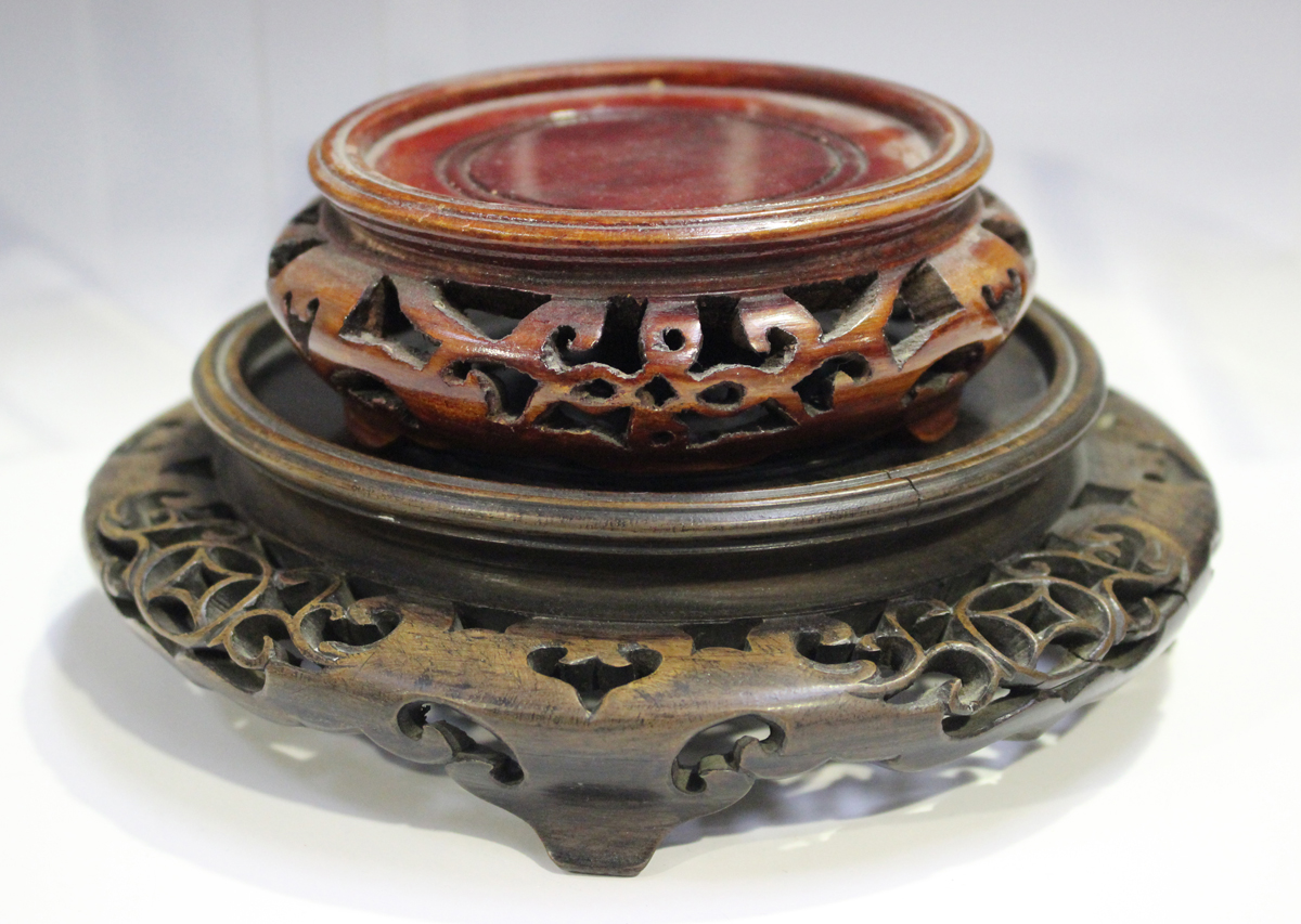 A Chinese hardwood circular stand, late 19th/early 20th century, carved with a keyfret and foliate - Image 11 of 19