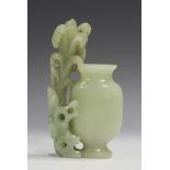 A Chinese pale celadon jade vase, Qing dynasty, the flattened shouldered body flanked by a carved