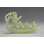 A Chinese pale celadon jade carving of a pleasure barge, the stern of the boat formed as a tree, one