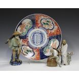 A Japanese Imari porcelain circular dish, Meiji period, painted and gilt with panels of Buddhistic