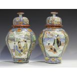 A pair of Japanese Imari porcelain vases and domed covers by Hichozan Shinpo, Meiji period, each