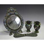 A Chinese white metal and enamelled dressing table mirror, late Qing dynasty, with circular bevelled