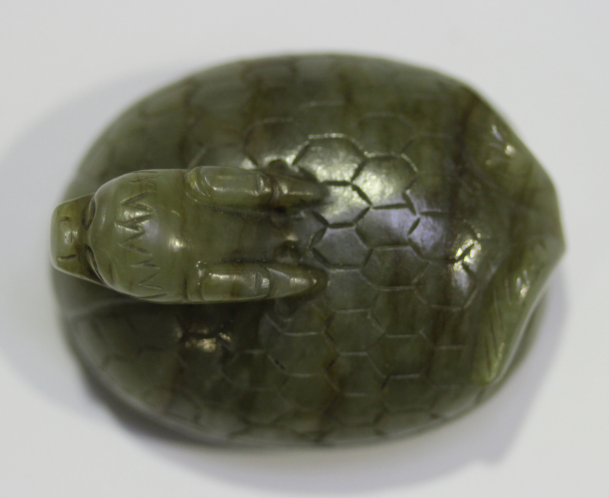 A Chinese carved celadon jade dragon pendant, 20th century, of oval shape, the stone with brown line - Image 7 of 10