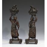 A pair of Japanese brown patinated cast bronze figures by Mori Homei, Meiji period, each modelled as