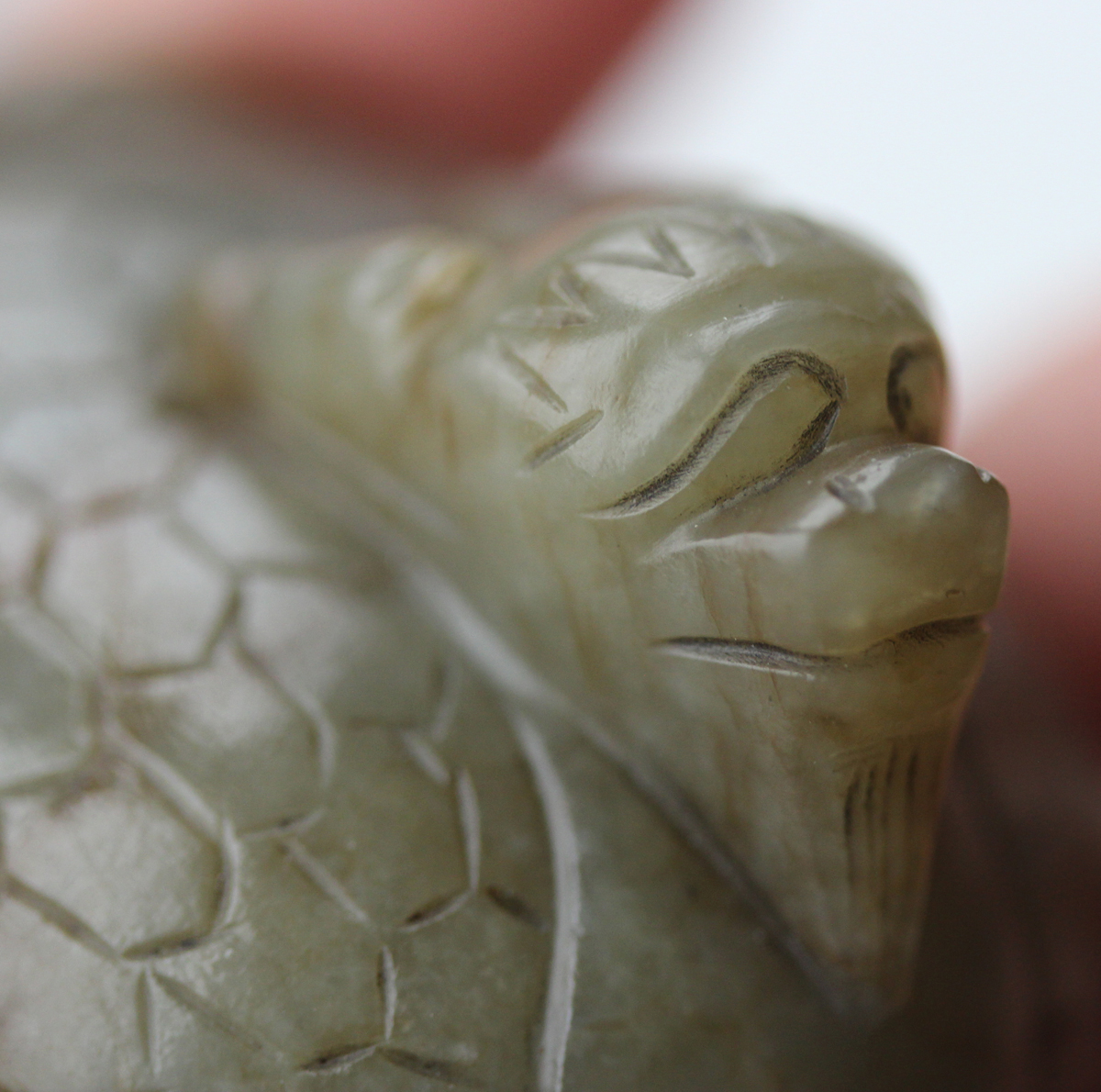 A Chinese carved celadon jade dragon pendant, 20th century, of oval shape, the stone with brown line - Image 3 of 10