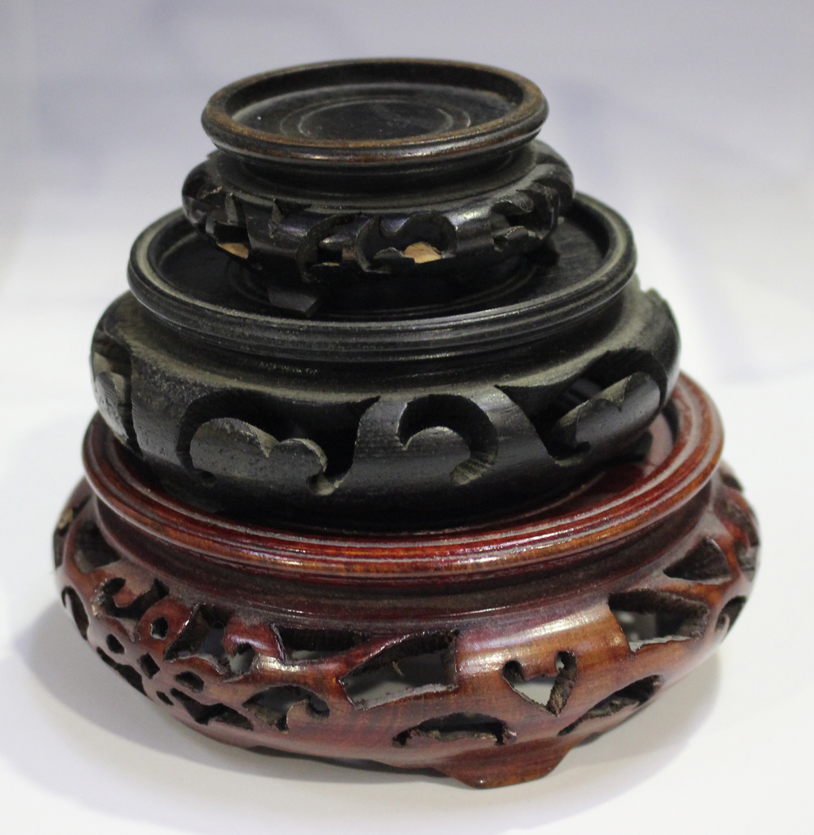 A Chinese hardwood circular stand, late 19th/early 20th century, carved with a keyfret and foliate - Image 6 of 19