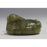 A Chinese carved celadon jade dragon pendant, 20th century, of oval shape, the stone with brown line