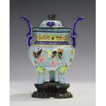 A Chinese Canton export enamel tripod censer and cover, 19th century, the oval body finely painted