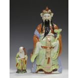 A Chinese porcelain figure of an immortal, mid-20th century, modelled standing wearing a long robe