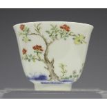 A Chinese porcelain wine cup, mark of Kangxi but later, painted in underglaze blue and polychrome