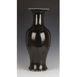 A Chinese monochrome glazed porcelain vase, Qing dynasty, the baluster body and flared neck