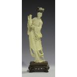 A Chinese carved ivory figure of a maiden, early 20th century, modelled standing wearing a long robe