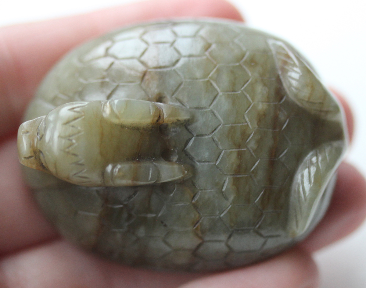 A Chinese carved celadon jade dragon pendant, 20th century, of oval shape, the stone with brown line - Image 2 of 10