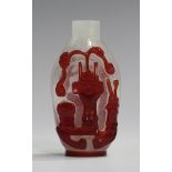 A Chinese Peking red overlay glass snuff bottle, late Qing dynasty, each side well-carved with