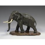 A Japanese brown patinated bronze model of an elephant, late Meiji period, by Seiya, modelled in a