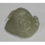 A Chinese pale celadon jade carving, carved as a hat tied with a ribbon bow and surmounted with