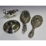 A small group of silver items, comprising a George V sauceboat with gadrooned rim and flying