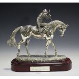 An Elizabeth II silver filled figure group of a racehorse and jockey, designed by David Geenty,