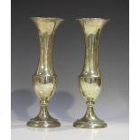 A pair of George V silver vases with flared necks, each raised on a circular base, Birmingham 1912