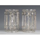 A pair of clear cut glass lustres, early 20th century, the baluster stems beneath circular tops,