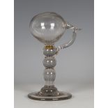 A glass lacemaker's oil lamp, late 18th/early 19th century, the globular reservoir raised on a