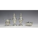 A pair of late Victorian silver pepper casters, each of spiral reeded ogee baluster form with