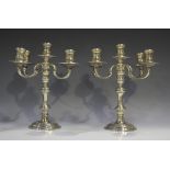 A pair of Elizabeth II silver four-branch five-light candelabra, each branch with turned sconce