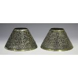 A pair of Cambodian silver and parcel gilt lamp shades, each of conical form, pierced and embossed