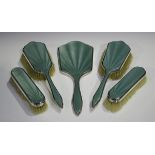 A George VI silver and sage green enamel five-piece dressing table set, comprising hand mirror, pair