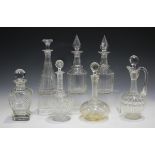 A mixed group of mostly cut glass decanters and stoppers, 19th century and later, including a pair