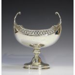 A George V silver centrepiece bowl, the oval boat-shaped body with pierced rim and scroll ends,