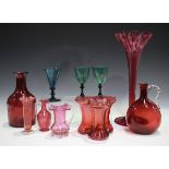 A small group of cranberry and green glass, 19th century and later, including a tapering fluted