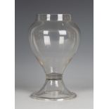 An apothecary's glass leech jar, 19th century, the baluster bowl with upturned rim, raised on a