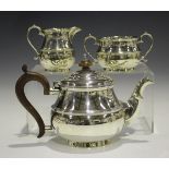 A George V silver three-piece tea set of circular baluster form, comprising teapot, milk jug and