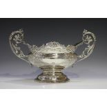 An Edwardian silver two-handled centrepiece bowl, the oval body embossed with flowers and