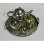 An Elizabeth II silver toy tea set, comprising teapot, milk jug, sugar bowl, teacup and saucer and