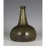 An olive green tinted onion shaped glass wine bottle, 18th century, with kick-in base and string