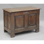 An early 18th century oak panelled coffer, the hinged lid with wire hinges and enclosing a